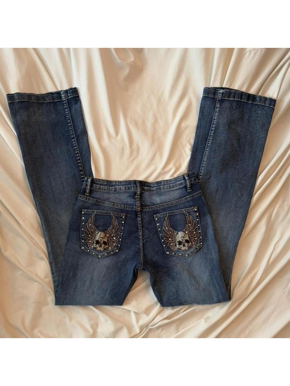 Dark wash low rise flare jeans with skull and wings embroidery